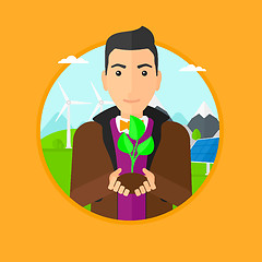 Image showing Man holding green small plant.