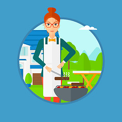 Image showing Woman cooking meat on barbecue grill.