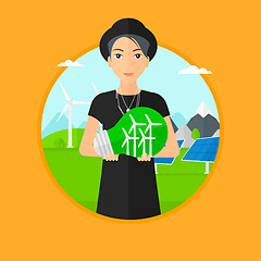 Image showing Woman holding lightbulb with wind turbines inside.