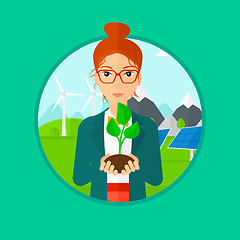 Image showing Woman holding green small plant.