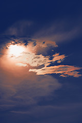 Image showing sunset with sun clouds over clouds