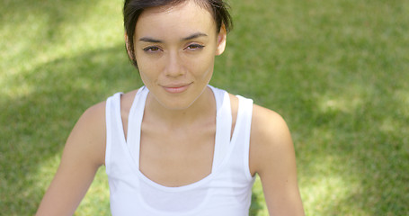 Image showing Calm young woman in white blouse with grin