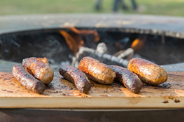 Image showing Grilling sausages on barbecue grill