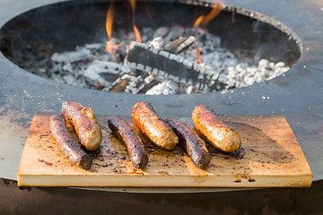 Image showing Grilling sausages on barbecue grill