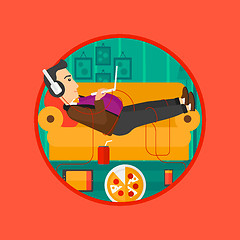 Image showing Man lying on sofa with many gadgets.