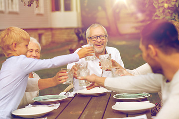 Image showing happy family having holiday dinner outdoors