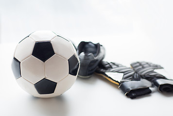 Image showing close up of soccer ball, boots and gloves on table