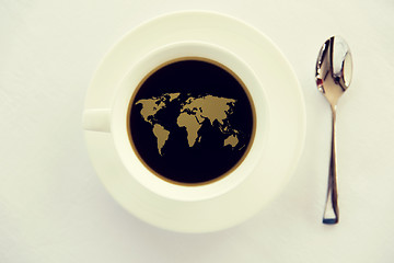 Image showing world map in cup of black coffee with spoon