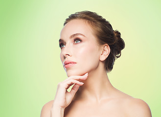 Image showing beautiful young woman touching her face