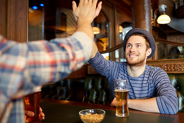 Image showing happy male friends making high five at bar or pub