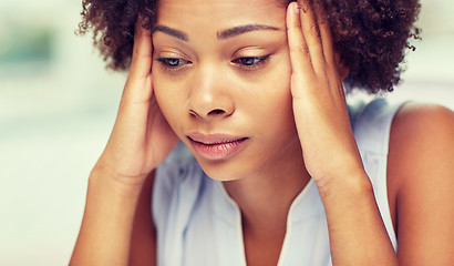 Image showing close up of african young woman touching her head