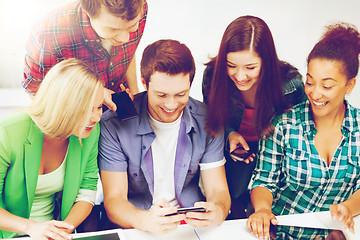 Image showing students looking into smartphone at school