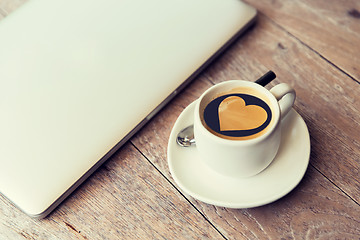 Image showing close up of laptop and coffee cup with heart shape