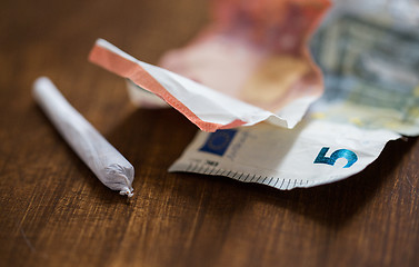 Image showing close up of marijuana joint and money