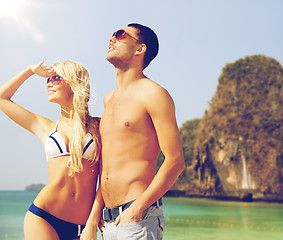 Image showing happy couple over exotic tropical beach background