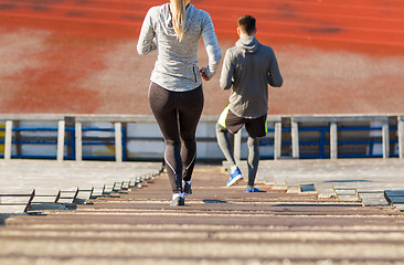 Image showing close up of couple running downstairs on stadium