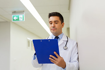 Image showing doctor writing to clipboard at hospital