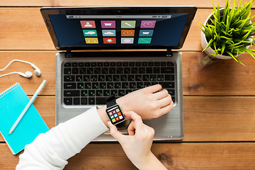 Image showing close up of woman with smart watch and laptop
