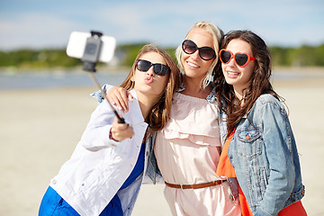 Image showing group of smiling women taking selfie on beach