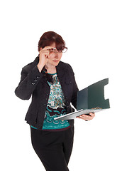 Image showing Businesswoman looking on her clipboard.