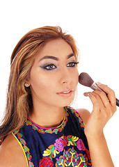 Image showing Woman putting makeup on face.