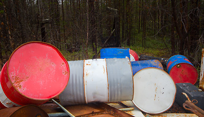 Image showing Height of mismanagement and irresponsibility. Colorful empty barrel of fuel left in forest