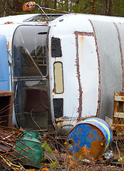 Image showing Fragment of trucking dump. Old bus and empty barrels out of fuel