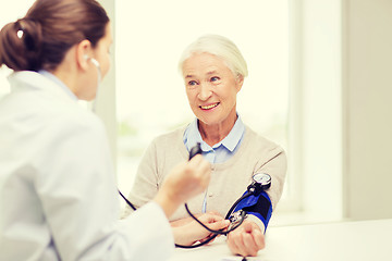 Image showing doctor with tonometer and senior woman at hospital