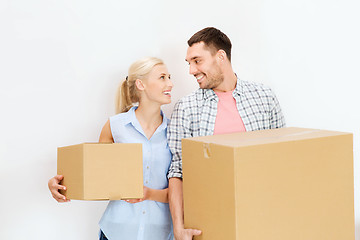 Image showing couple with cardboard boxes moving to new home