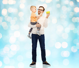 Image showing happy father and little son with green apple