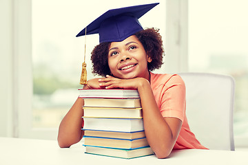 Image showing happy african bachelor girl with books at home