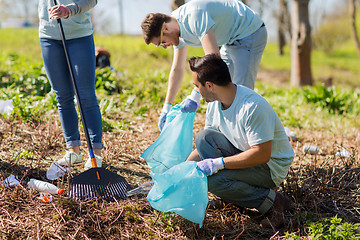Image showing volunteers with garbage bags cleaning park area