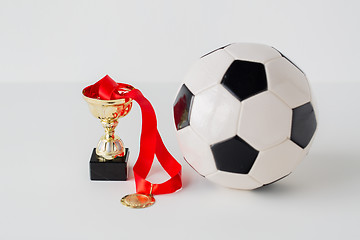 Image showing close up of football ball, golden cup and medal