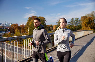 Image showing happy couple running outdoors