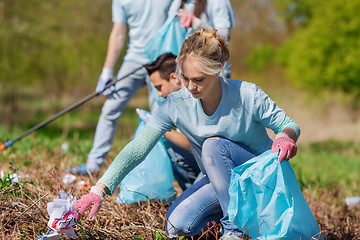 Image showing volunteers with garbage bags cleaning park area