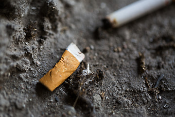 Image showing close up of smoked cigarette butt on ground
