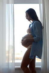 Image showing happy pregnant woman with big bare tummy at home