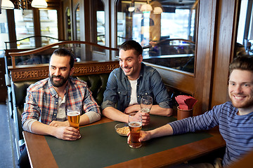 Image showing happy male friends drinking beer at bar or pub