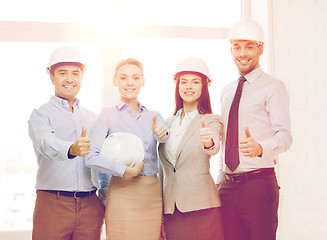 Image showing happy business team in office showing thumbs up