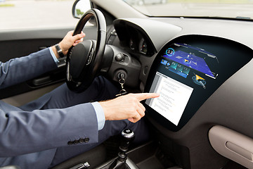 Image showing close up of man driving car with navigation system