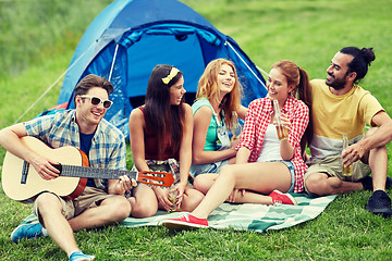 Image showing happy friends with drinks and guitar at camping