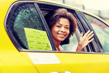 Image showing happy african american woman driving in taxi