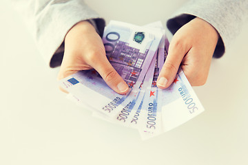 Image showing close up of woman hands counting euro money