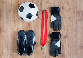 Image showing close up of soccer ball, boots, gloves and medal
