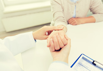 Image showing doctor checking senior woman pulse at hospital