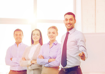 Image showing businessman in office pointing finger at you