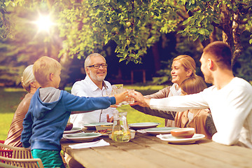 Image showing happy family having holiday dinner outdoors