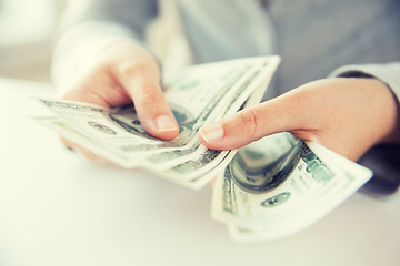 Image showing close up of woman hands counting us dollar money