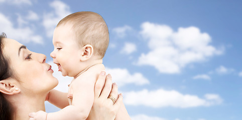 Image showing happy mother kissing adorable baby