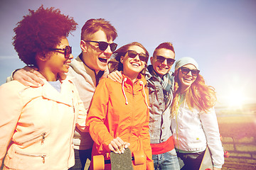 Image showing happy teenage friends with longboards on street